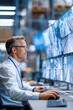 © Anna - Industrial surveillance control room with operator monitoring multiple security screens in a warehouse for design, poster and background use in monitoring dashboards