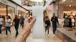 © FryArt - Person holding long paper receipt in shopping mall