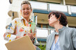 © ADDICTIVE STOCK - Two women discussing business outdoors