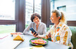 © ADDICTIVE STOCK - Women enjoying a lunch break in a modern setting