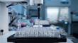 © sangita - Robotic pipette dispensing liquid into microplate, automated laboratory liquid handling system