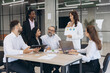 © anatoliycherkas - Business professionals discuss financial data charts, focusing on company growth strategies and teamwork