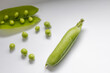 © Olga - Fresh green pea pod with organic peas isolated on white background. Close up view of healthy legumes, raw vegetable ingredient, natural harvest, vegan nutrition, vegetarian eating, diet concept.
