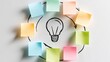 © 69 - Creative brainstorming concept with colorful blank sticky notes arranged in circle around hand-drawn light bulb and arrows on white background
