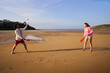 © Alvaro Lavin/Stocksy - Young couple playing matkot paddle ball on sandy beach