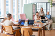 © Luis Velasco/Stocksy - Group of Coworkers Meeting in an Office Workspace During the Day