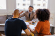 © BONNINSTUDIO/Stocksy - Financial advisor consulting clients about financial planning