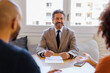 © BONNINSTUDIO/Stocksy - Financial advisor consulting clients about financial planning