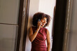 © BONNINSTUDIO/Stocksy - Woman laughing enjoying phone conversation at office