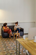 © BONNINSTUDIO/Stocksy - Businesswoman discussing business in office lounge
