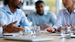 © Nataliya - Faceless business team disagreement during meeting at modern office with coworkers debating project ideas in professional conflict resolution, diverse group communication concept,