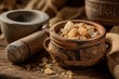 © changchun - Ancient terracotta pot containing resin pieces with grinding tools, warm lighting.