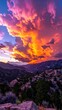 © PUTRABATARA - A dramatic sunset paints the sky with vibrant colors over a mountainous landscape.
