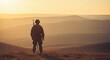 © RayyanRazak - Lone soldier silhouetted against a vast mountainous landscape at sunset