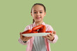 © Pixel-Shot - Little girl with plate of tasty sausages on green background