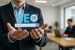 © James - Businessman holding virtual search engine optimization interface with target icon concept