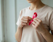 © ABDULMUNNAF - A person wearing a plain light pink t-shirt holding a small pink ribbon against their ad social media download product banner template event festive festival 2026 2027 2028