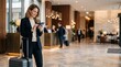 © Eve - Elegant blonde Caucasian businesswoman using smartphone standing with suitcase in luxury hotel lobby. Confident female executive traveling for corporate work assignment. Generative AI