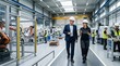 © PULOCK - Smart factory floor engineers discussing data on a tablet with robotics