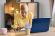 © Dejan - Woman feeling stressed and confused while making an online credit card payment, typing on laptop with a worried expression
