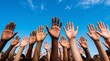 © FahVecStudio - Diverse Hands Raised Against a Clear Blue Sky Symbolizing Unity, Diversity, and Community Support