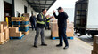 © logonv - Two warehouse workers having an intense disagreement at a loading dock. Men arguing during shipment of goods. Conflict at workplace, stressful delivery process and logistics management.