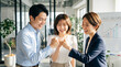 © k-studio - Group of happy young business people celebrating with fist bump in office