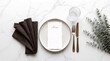 © Cans De Blur - Flat lay of elegant table setting mockup with blank menu card, plate and eucalyptus on marble background.