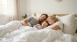© Masque - A young family with a small child sleeping peacefully in a large comfortable bed.