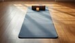 © Md Mahabub - Yoga mat with candle in sunlit room