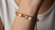 © Henderson - Elegant gold chain bracelet with white pearls on a woman wrist