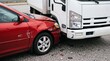 © Olga Ко - Traffic accident involving a red car and a white delivery truck, damaged bumper and debris on asphalt, auto insurance claim concept