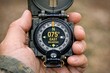 © Fotograf - A person holds a compass in their hand, a symbol of navigation and guidance