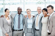 © peopleimages.com - Corporate, portrait and business people hug in lobby for team, partnership and about us for insurance. Professional, happy and men with woman for company pride, trust and assurance for broker service