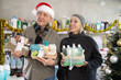 © JackF - Elderly couple shopping for Christmas presents together at home goods store