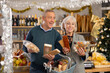 © JackF - While shopping on eve of New Year holidays, elderly couple filled basket with groceries, choosing sweets. They are considering nougat, panellets, marzipan. Couple consult before buying dessert