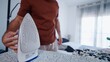 © FranciscoJavier - Man ironing clothes at home, prepping attire for the day