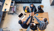 © aFotostock - Top view of MultiEthnics Teamwork high five hands stack shakehand together. Collaboration Team Meeting in Conference Room. Diversity Partner Business Meeting brainstorm hand holding teamwork consult