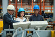 © eakgrungenerd - Happy Asian engineer manager factory worker team manufacturing plant wearing hardhat industry professionals smiling looking machine control panel working together industrial workshop setting