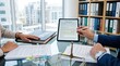 © Emma - Lawyers reviewing master agreement contract on tablet in modern office, legal consultation meeting, attorney pointing at digital document screen, business negotiation discussion...