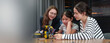 © eggeeggjiew - Teacher guides students building a robotics project in a STEM classroom, encouraging teamwork, coding, engineering on innovation.