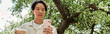 © LIGHTFIELD STUDIOS - Young man enjoying a peaceful moment at an outdoor garden cafe