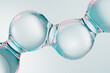 © Iana Kunitsa - Abstract transparent molecular structure with glossy glass spheres on a clean background. Futuristic skincare, collagen, hyaluronic acid and cosmetic serum concept, 3D render with copy space.