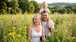 © tom - Happy Young Family with Toddler Son Playing in Wildflower Meadow during Summer