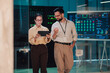 © Zamrznuti tonovi - It professionals analyzing data on tablet and screen in server room, ensuring network security and cloud computing infrastructure