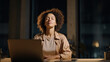 © Visual Field - Young businesswoman practicing mindfulness meditation during a late night work break with laptop in a modern office for workplace mental wellbeing