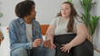 © Krakenimages.com - Woman holds pregnancy test on bed while partner takes her hand and they exchange quiet focused looks; uncertainty support.
