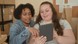 © Krakenimages.com - Woman holds tablet while man points to its screen in a small business building; collaboration planning.