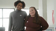 © Krakenimages.com - Man and woman smiling with arm around shoulder, wearing voted stickers beside a ballot box and small us flag inside a building; civic pride.