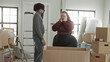 © Krakenimages.com - Man and plus size woman stand by open moving box, man hand on forehead and woman touches face in building; moving day frustration together.